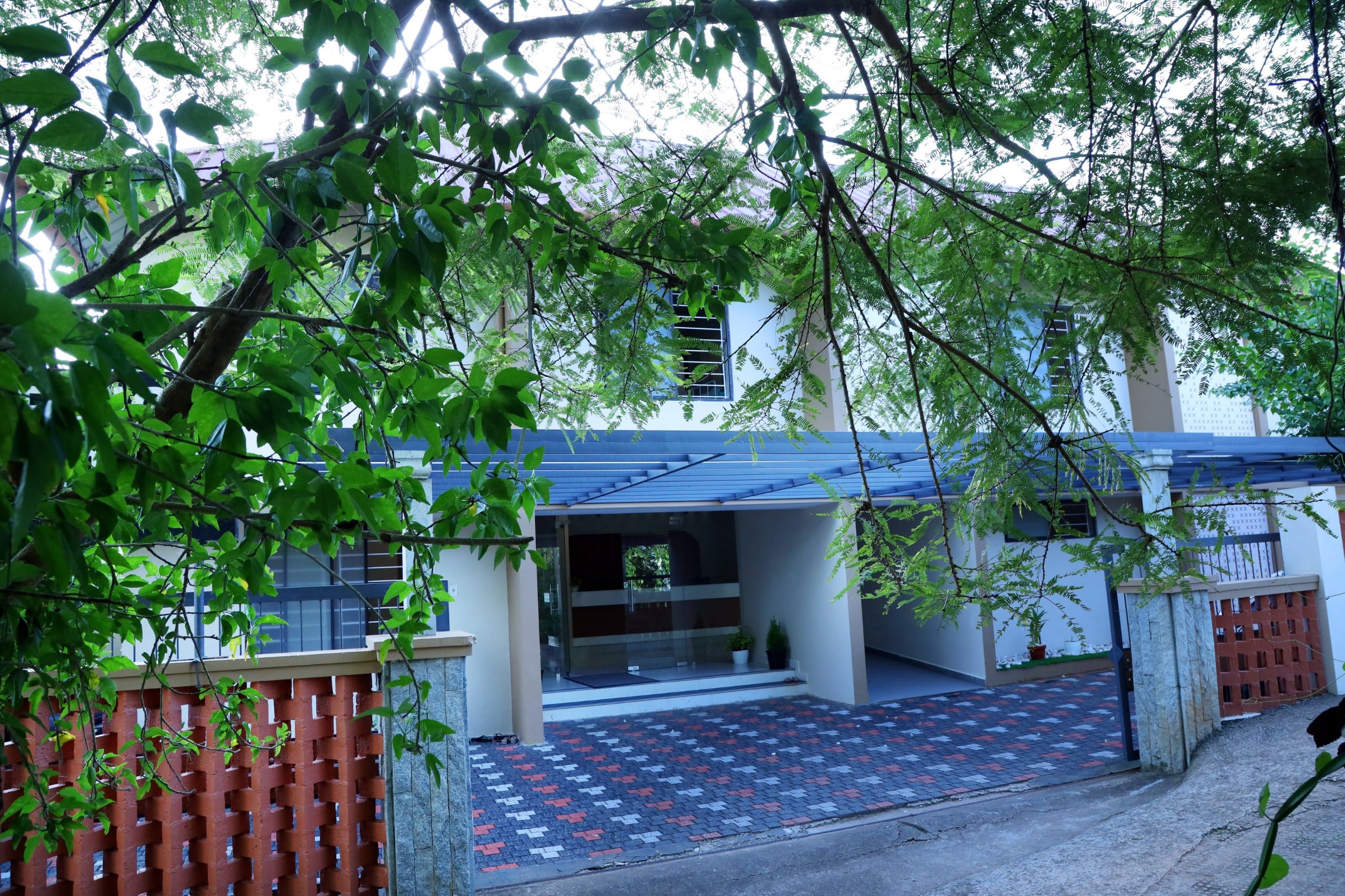 Centre entrance framed by peaceful greenery